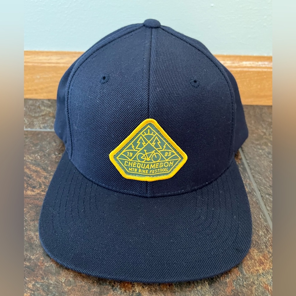 Chequamegon MTB bike festival blue flat brim hat.